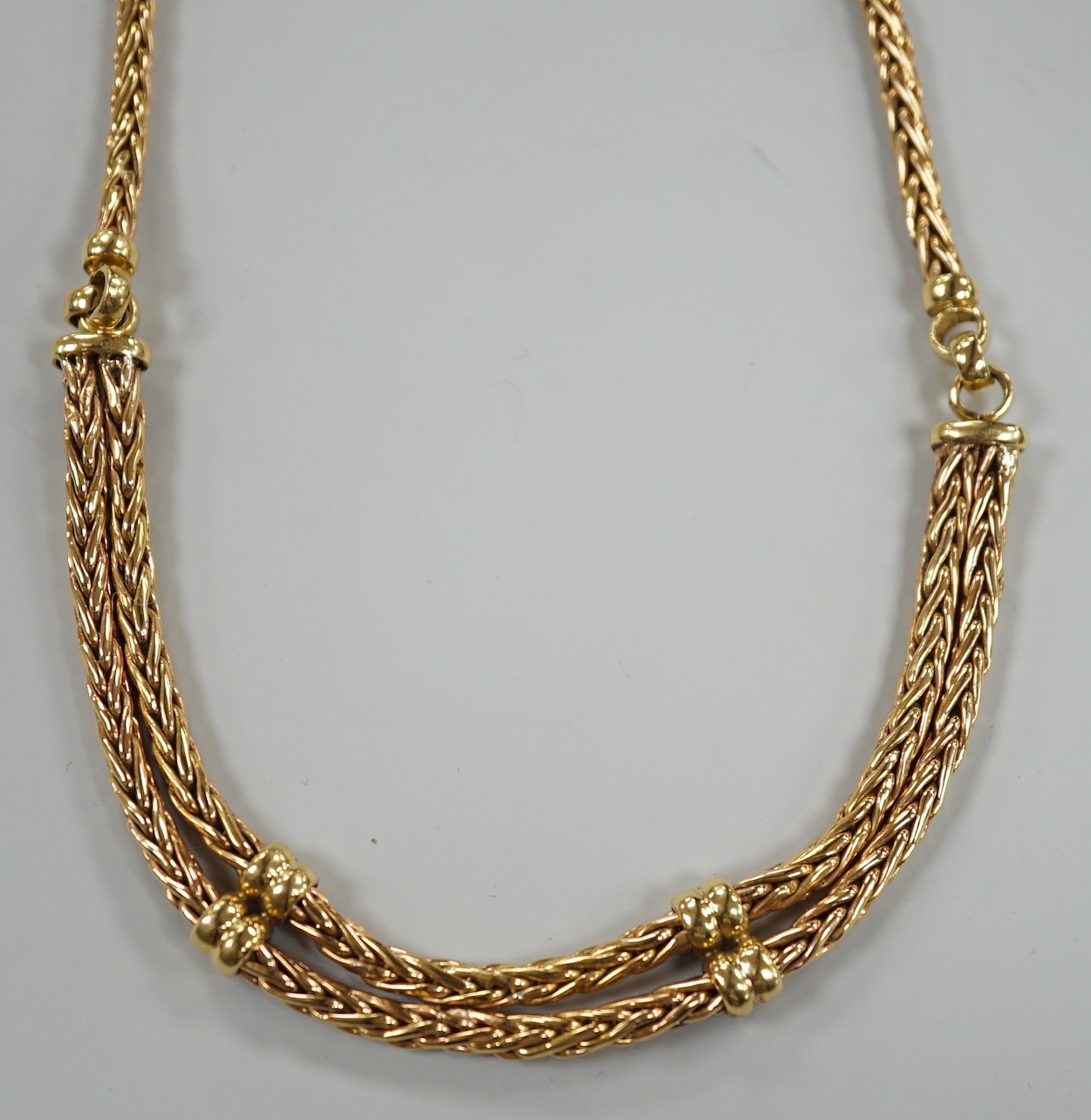 A modern continental yellow metal, single and twin strand interwoven link necklace, approximately 40cm, 44.6 grams.